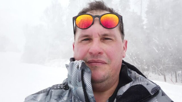 Man stands alone against white snowstorm and snow storm, a snowfall.