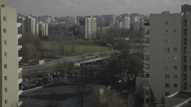 Busy suburban highways with traffic and intersections, as seen from a balcony of a high story apartment building, starts with defocused image, a 4K (Sony S-Log) video clip, Warsaw, Poland.