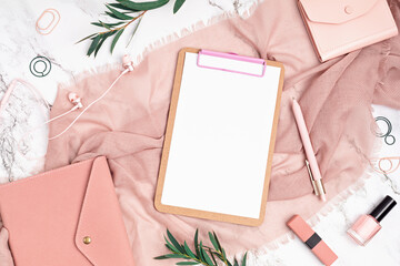 Desktop with notebook and woman accessories in pink color. Home office, social media blog,...