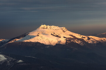 Naklejka premium View of Larrun mountain covered by snow at a winter evening; Basque Country.
