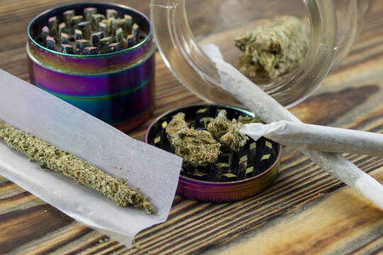 Medical Marijuana buds, weeds and grinder close up. Wooden backdround. Herbal medicine