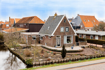 Fototapeta na wymiar Residential buildings and canal in Hindeloopen, Netherlands, Europe