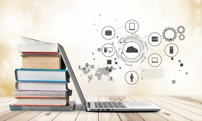 Stack of books with a modern laptop on the table