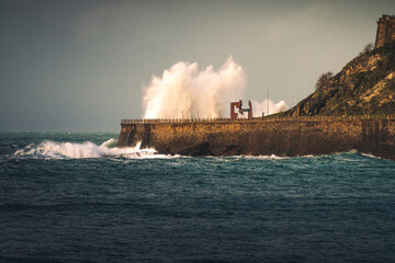 Naklejka premium Big waves hitting the coast at Donostia-San Sebastian; Basque Country.