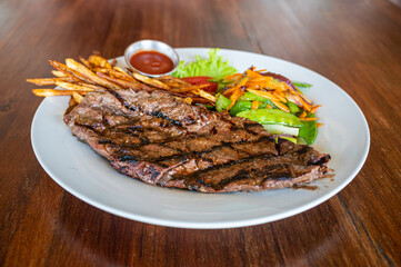 Grilled Steak Dinner with Vegetables on White Plate