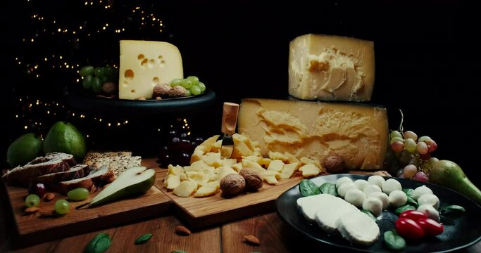 Assortment of different cheese types on wooden background. Cheese background. Slide shot.