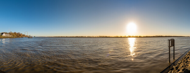 Wedel, Germany, near Hamburg. The river Elbe close to Schulau on a sunny winter day at sunset.