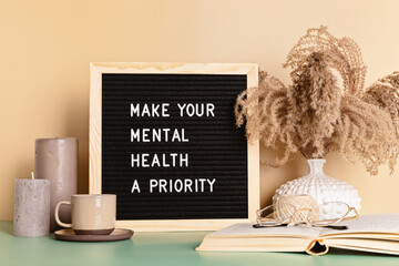 Make your mental health a priority motivational quote on the letter board. Inspiration psycological text - obrazy, fototapety, plakaty
