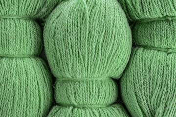 The texture of the wool yarn. Skeins of wool yarn in threads for knitting clothes.