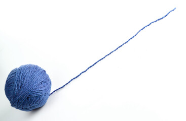 A ball of blue yarn with a long thread located diagonally. Isolated on white background.