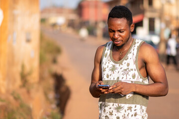 young black man uses his phone to text