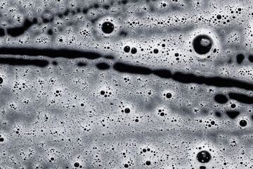Soap foam on black. Abstract background of cleaning agent.