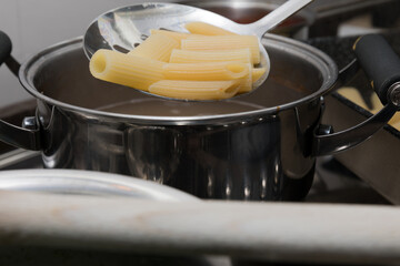 Cooking Italian pasta is a good way to spend happy moments with the family.  Penne rigate are a typical Italian product.