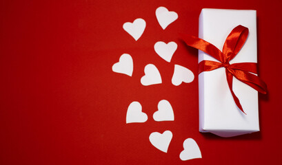 Banner. Velentines Day. Flat or white hearts, white handmade gift boxes, white hearts on a red background. Copy space. The concept of holidays and love