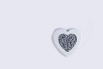 White heart with grey pearls. Minimal Valentines day background with copy space.