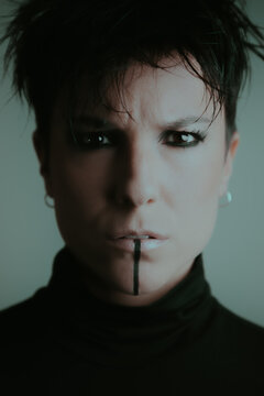 Confident woman looking at the camera with dark makeup