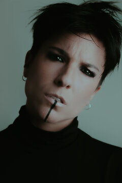 A powerful portrait of a confident woman looking at camera with very dark eyes
