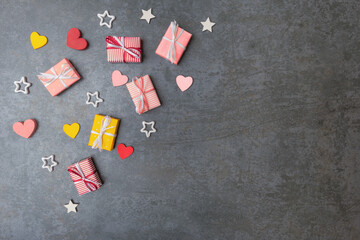 Valentines day background. Gift boxes and decorative hearts on stone background with copy space