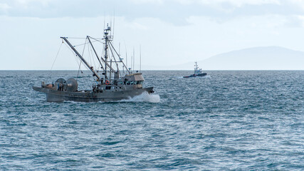 Fishing boats in the waves