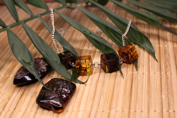 raw amber and amber in products on a natural background