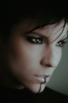 Close up portrait of a beautiful serious woman with dark eyes