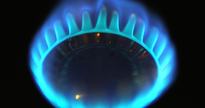 Camping gas stove being turned on by a fire match. Natural gas concept.