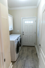 small narrow laundry room with washer and dryer