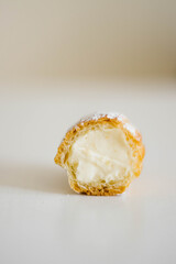 A homemade french dessert eclair with filling inside