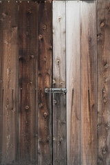 Old weathered wooden door with lock