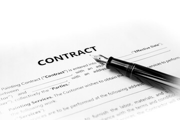 Close-up of a silver pen on docunent contract. Legal contract signing, buy sell real estate contract agreement sign on document paper with black pen