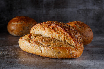 Assortment of baked bread on wooden table background Fresh fragrant bread on the table. Food concept.