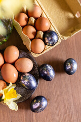 process of painting Easter eggs. Preparation for the feast of Holy Easter. Festive still life top view. Springtime mood. Beige and black silver egg. Creative decoration handmade cozy warm beautiful