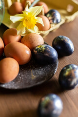 process of painting Easter eggs. Preparation for the feast of Holy Easter. Festive still life top view. Springtime mood. Beige and black silver egg. Creative decoration handmade cozy warm beautiful