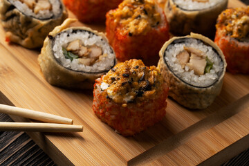 sushi close-up on a wooden board and sticks
