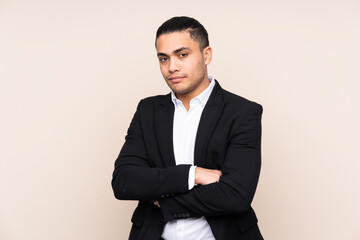 Asian business man isolated on beige background thinking an idea