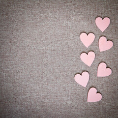 Heart drawn on a canvas. Valentine's Day. Pink wooden hearts on a fabric background.