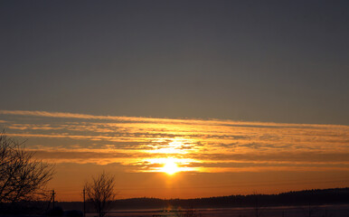 Golden rays of the rising sun in the dark sky, close-up