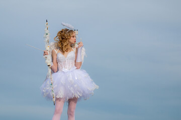Angel teen with arrow and wings. Charming curly little girl in white dress and wings - angel cupid...