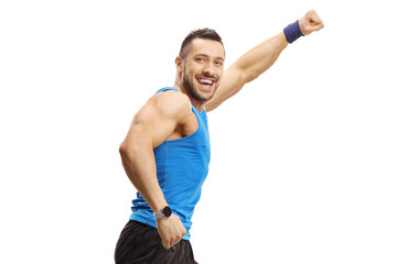 Muscular young man running and gesturing with hand