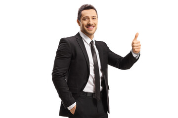 Smiling man in a black suit showing thumbs up