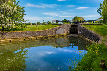 Fototapeta na wymiar A close up view of a lock gate on the Oxford Canal beside the village of Napton, Warwickshire in summertime