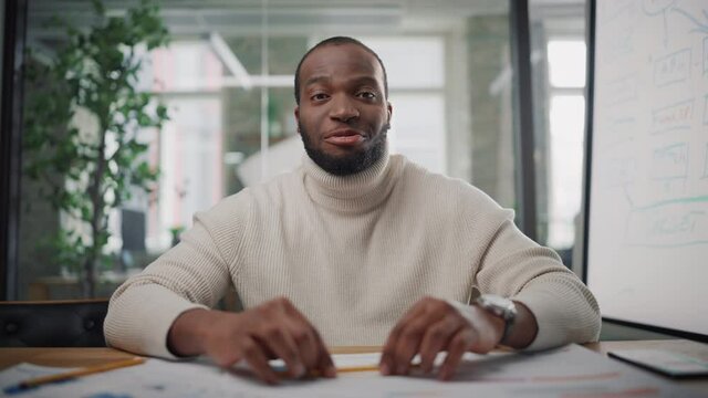 Point of View from Camera with Handsome Young Black Project Manager Making a Video Call in Creative Office Environment. Happy African American Male Specialist Talking to Colleague Over a Live Camera.