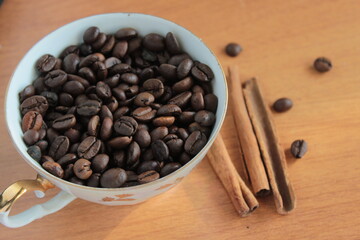 coffee beans in a cup with cinnamon