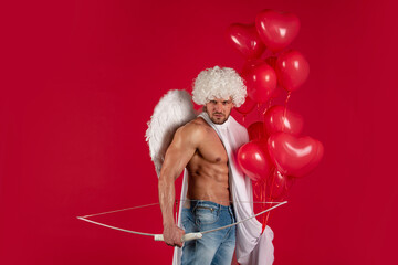 Valentines Day. Sexy male angel. Arrow of love. Handsome athlete man with angels wings. Cupid,...
