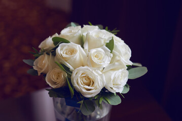 gold rings and a beautiful bridal bouquet of roses on the background. details, wedding traditions. close-up, macro