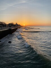 the setting sun among the breakwaters
