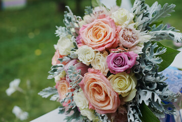 gold rings and a beautiful bridal bouquet of roses on the background. details, wedding traditions. close-up, macro