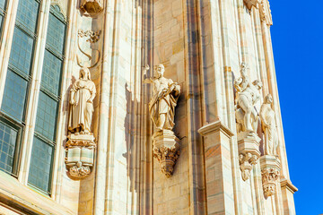 Facade of Milan Cathedral Duomo di Milano with Gothic spires and white marble statues. Top tourist...