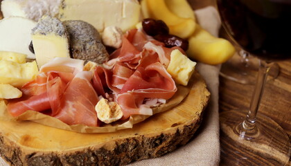 different types of cheeses with delicacy meat wooden surface selective focus. cheese platter.