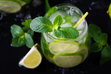 Refreshing summer alcoholic cocktail mojito with ice, fresh mint and lime.